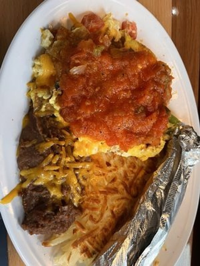 Breakfast plate with eggs, salsa, beans, and hash browns
